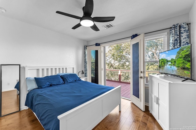 bedroom featuring ceiling fan, wood-type flooring, and access to outside