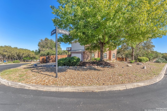 obstructed view of property with a garage