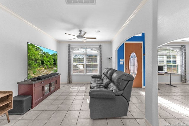 living room with ceiling fan, crown molding, and light tile patterned flooring