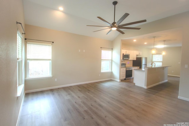 kitchen with white cabinets, a wealth of natural light, and appliances with stainless steel finishes