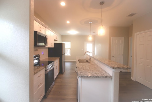 kitchen featuring white cabinetry, sink, stainless steel appliances, dark hardwood / wood-style floors, and pendant lighting