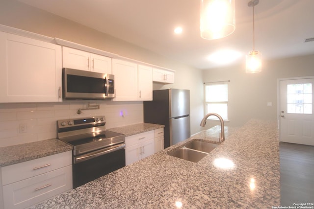 kitchen with white cabinets, plenty of natural light, sink, and appliances with stainless steel finishes