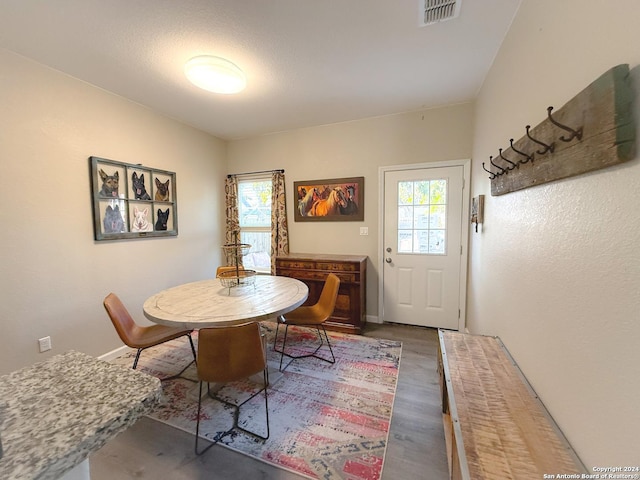 dining space with dark hardwood / wood-style flooring