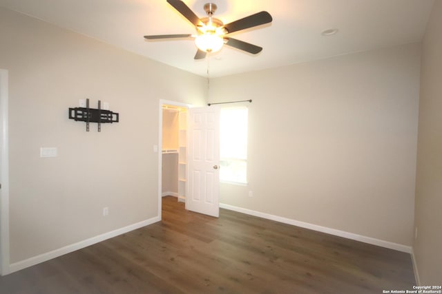 spare room featuring ceiling fan and dark wood-type flooring