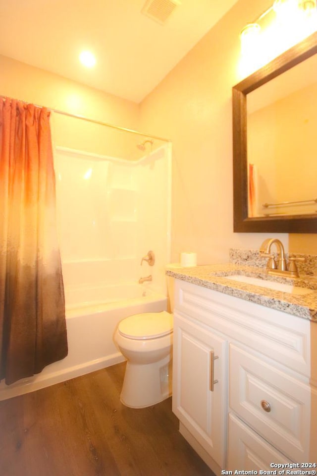 full bathroom featuring wood-type flooring, vanity, toilet, and shower / bath combination with curtain