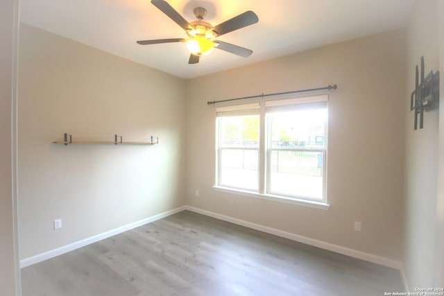 unfurnished room featuring ceiling fan and light wood-type flooring