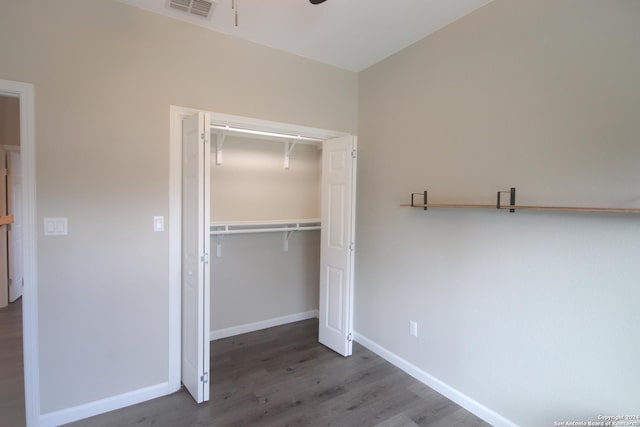 unfurnished bedroom with dark hardwood / wood-style floors and a closet