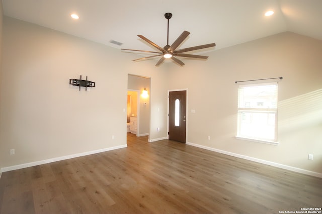 unfurnished room featuring dark hardwood / wood-style floors, high vaulted ceiling, and ceiling fan