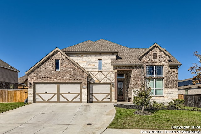 view of front facade featuring a garage and a front lawn