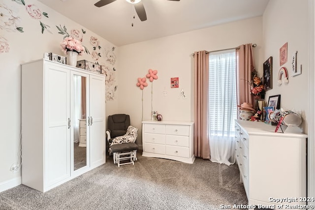 carpeted bedroom with multiple windows and ceiling fan