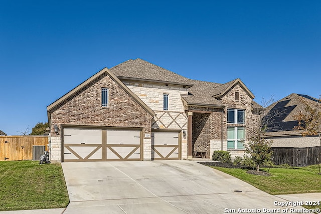 view of front of house featuring a garage and a front yard