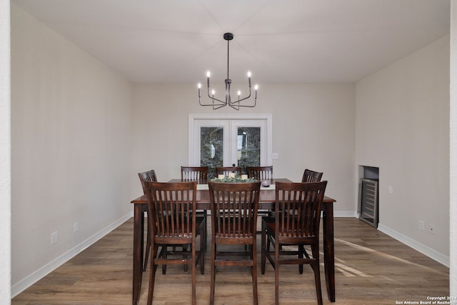 dining room featuring a notable chandelier and dark hardwood / wood-style flooring