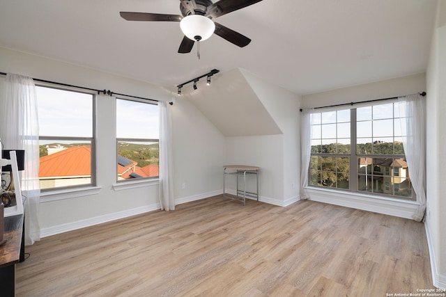 bonus room featuring light wood-type flooring, plenty of natural light, and ceiling fan