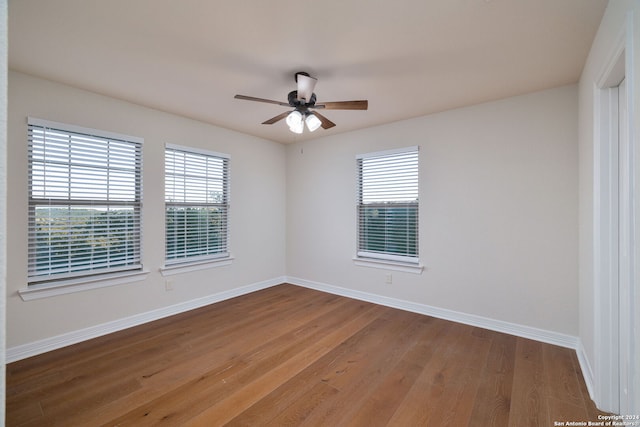 unfurnished room with ceiling fan, plenty of natural light, and hardwood / wood-style floors