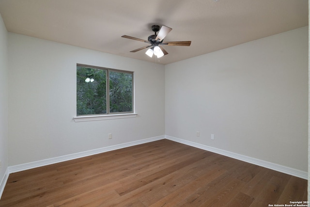 empty room with ceiling fan and hardwood / wood-style floors