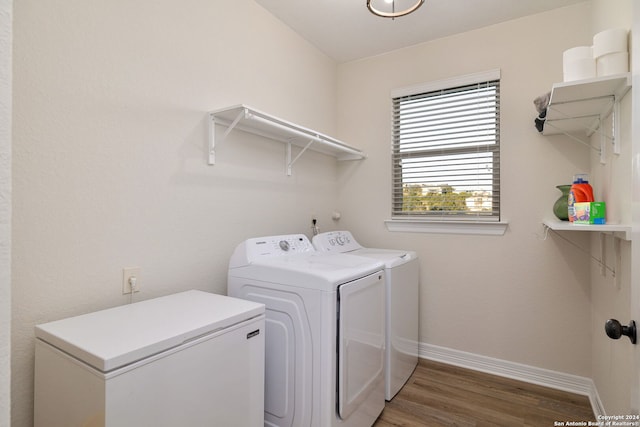 laundry room with dark hardwood / wood-style flooring and washer and dryer