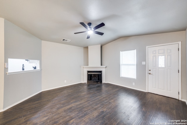 unfurnished living room with vaulted ceiling, ceiling fan, and dark wood-type flooring