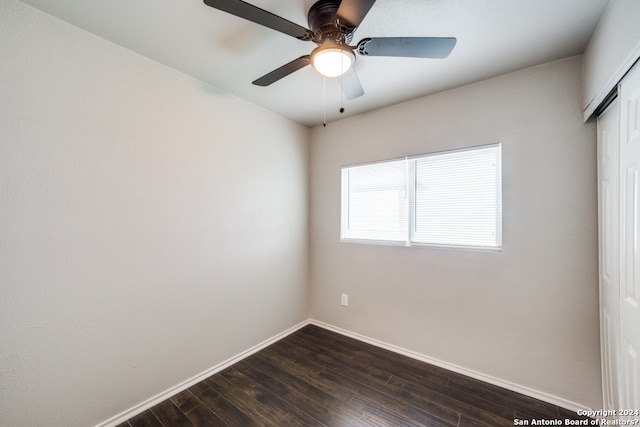 spare room with ceiling fan and dark wood-type flooring