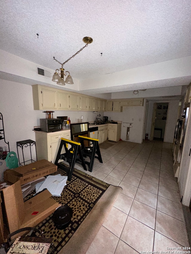 dining area featuring a chandelier, light tile patterned floors, and a textured ceiling