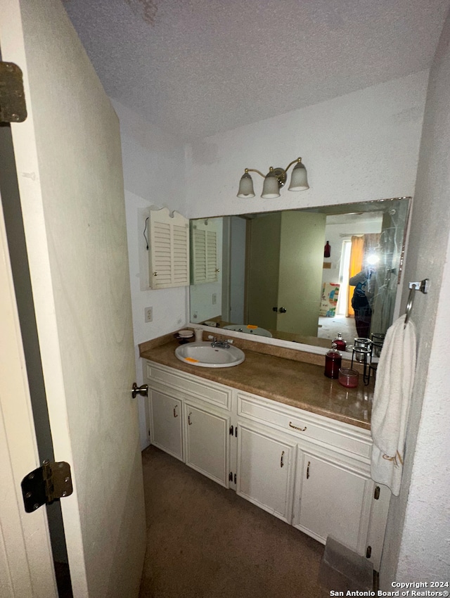 bathroom featuring vanity and a textured ceiling