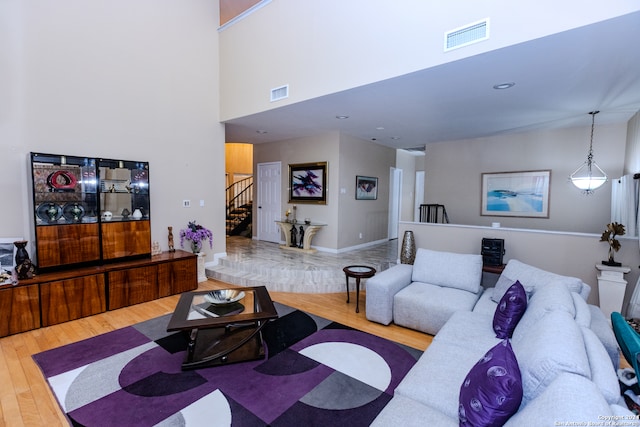 living room featuring hardwood / wood-style floors and a high ceiling