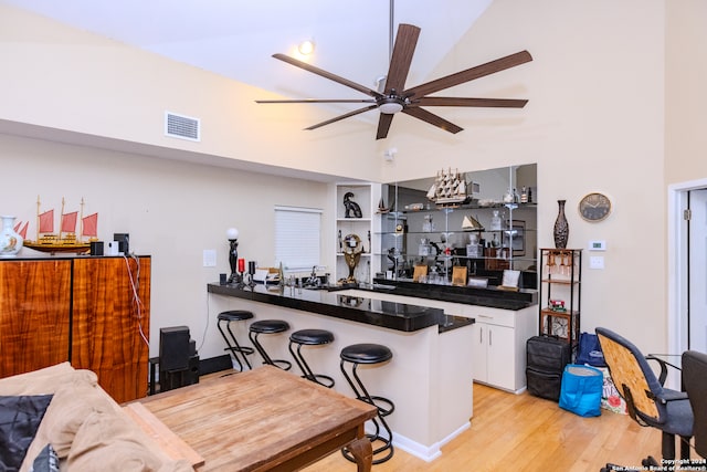 bar with white cabinetry, ceiling fan, and light hardwood / wood-style floors