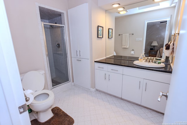 bathroom with vanity, toilet, and a shower with shower door