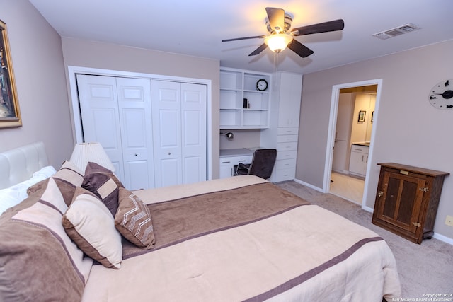 bedroom with ceiling fan, light carpet, connected bathroom, and a closet