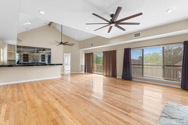 206 Bluff Holw, San Antonio, TX 78216 - unfurnished living room with a ceiling fan, beamed ceiling, wood finished floors, recessed lighting, and high vaulted ceiling