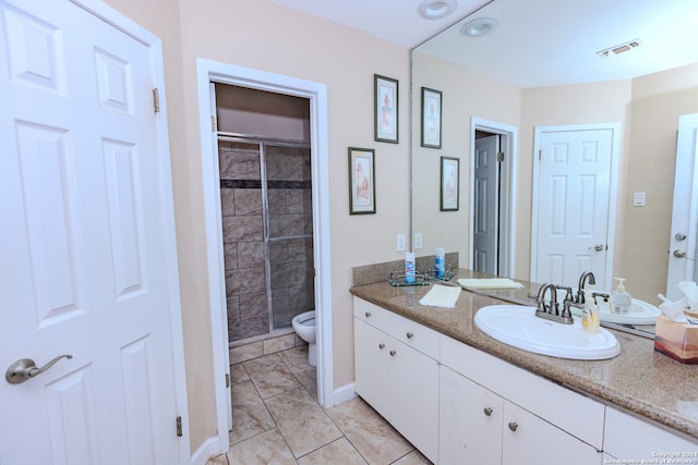 bathroom with walk in shower, tile patterned flooring, vanity, and toilet