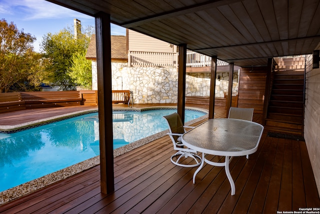 view of pool with a wooden deck