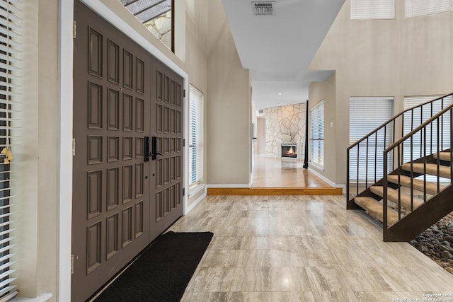 206 Bluff Holw, San Antonio, TX 78216 - foyer featuring a towering ceiling, stairs, a fireplace, and baseboards