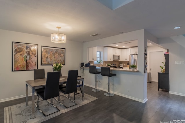 dining space featuring dark hardwood / wood-style flooring