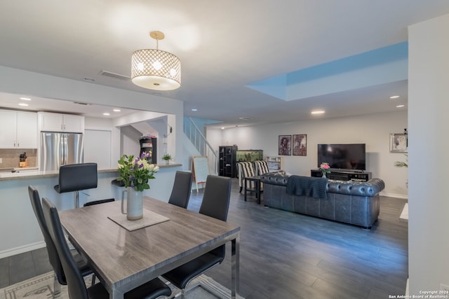 dining space featuring dark wood-type flooring