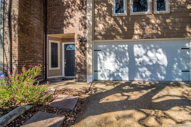 doorway to property with a garage