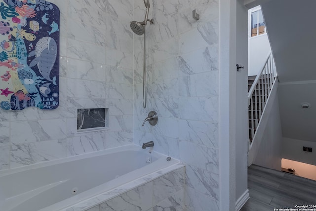 bathroom featuring tiled shower / bath