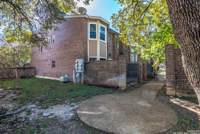 view of side of property with central AC