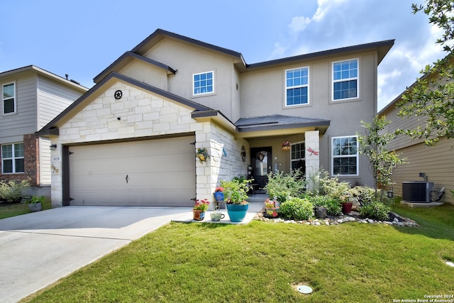 view of front of house with a front lawn, a garage, and cooling unit