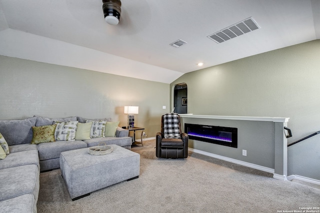 living room featuring carpet flooring, vaulted ceiling, and ceiling fan