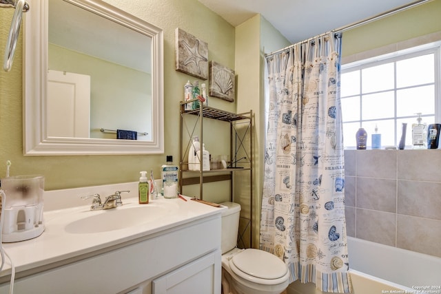 full bathroom with vanity, shower / bath combo, and toilet