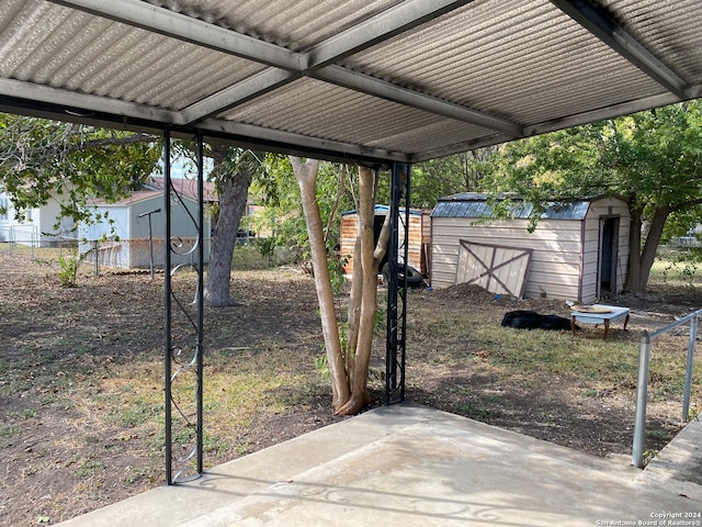 view of yard featuring a patio and a storage unit