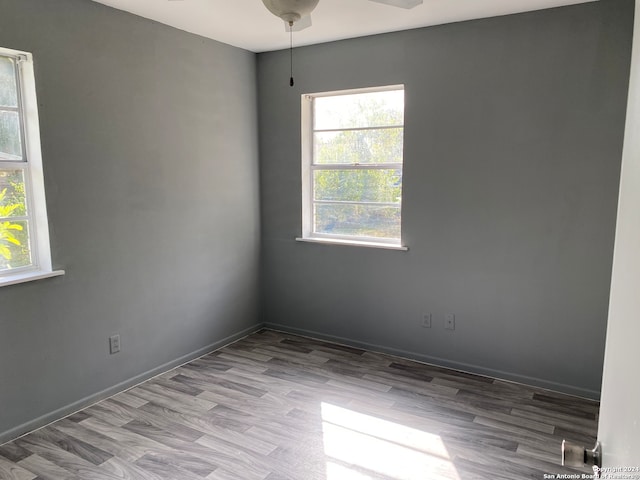 unfurnished room with hardwood / wood-style floors and ceiling fan