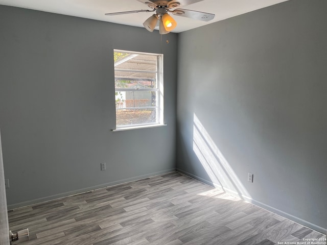 empty room featuring ceiling fan and light hardwood / wood-style flooring