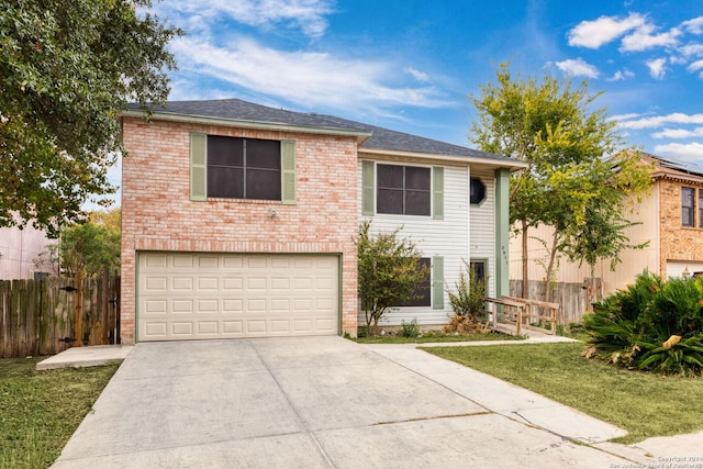 view of front of property with a garage and a front lawn