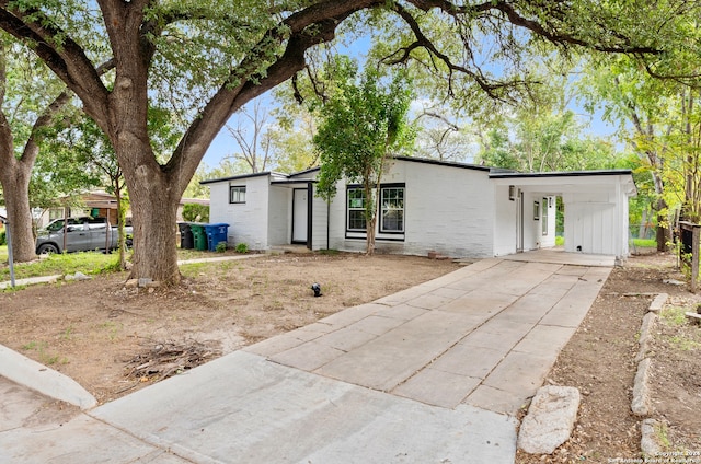 ranch-style home featuring a carport