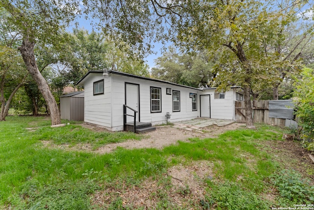 rear view of house with a yard