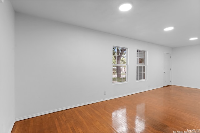 spare room with wood-type flooring