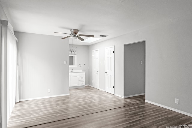 spare room featuring ceiling fan, dark wood-type flooring, and sink