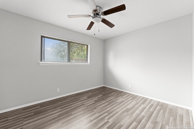 unfurnished room with hardwood / wood-style flooring and ceiling fan