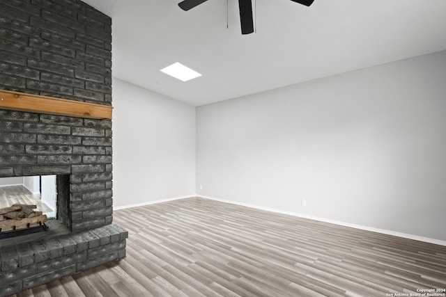 unfurnished living room featuring a fireplace, ceiling fan, and hardwood / wood-style floors